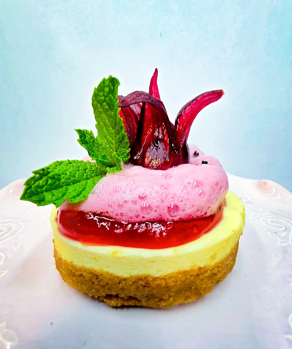 Lemon cake with hibiscus flower and rose syrup foam
