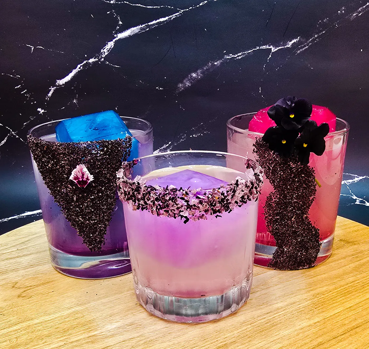 A colourful cocktail with a hibiscus salt rim